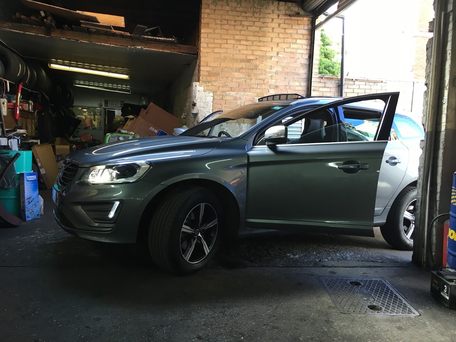 Mechanic working underneath a car on the ramp at Daniel Motors